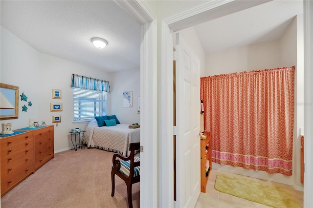 carpeted bedroom featuring a textured ceiling