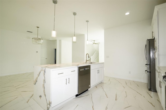 kitchen with sink, pendant lighting, stainless steel appliances, and white cabinets