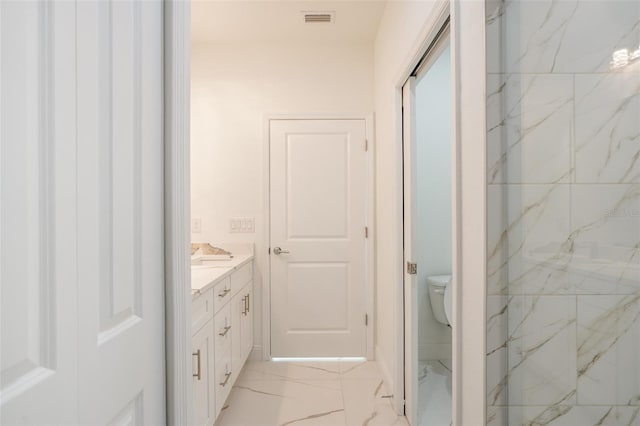 bathroom featuring vanity and toilet