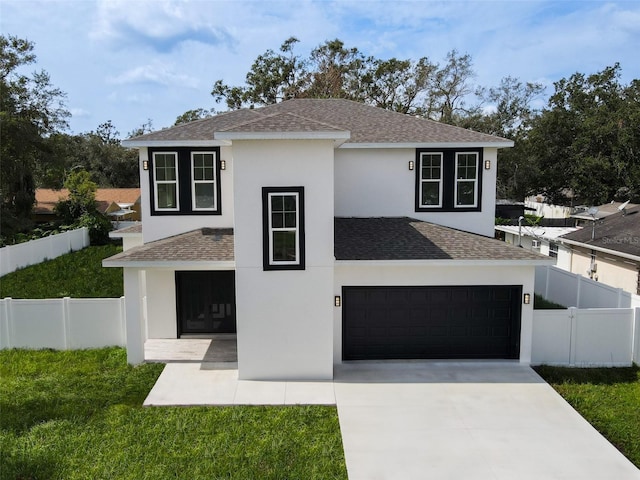 view of front of house with a front lawn and a garage