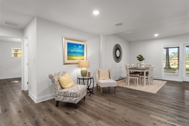 sitting room with dark wood-type flooring