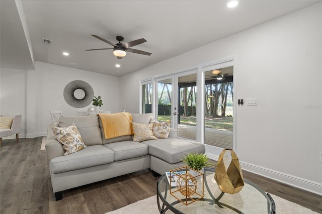 living room with dark wood-type flooring, french doors, and ceiling fan