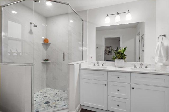 bathroom featuring walk in shower and vanity