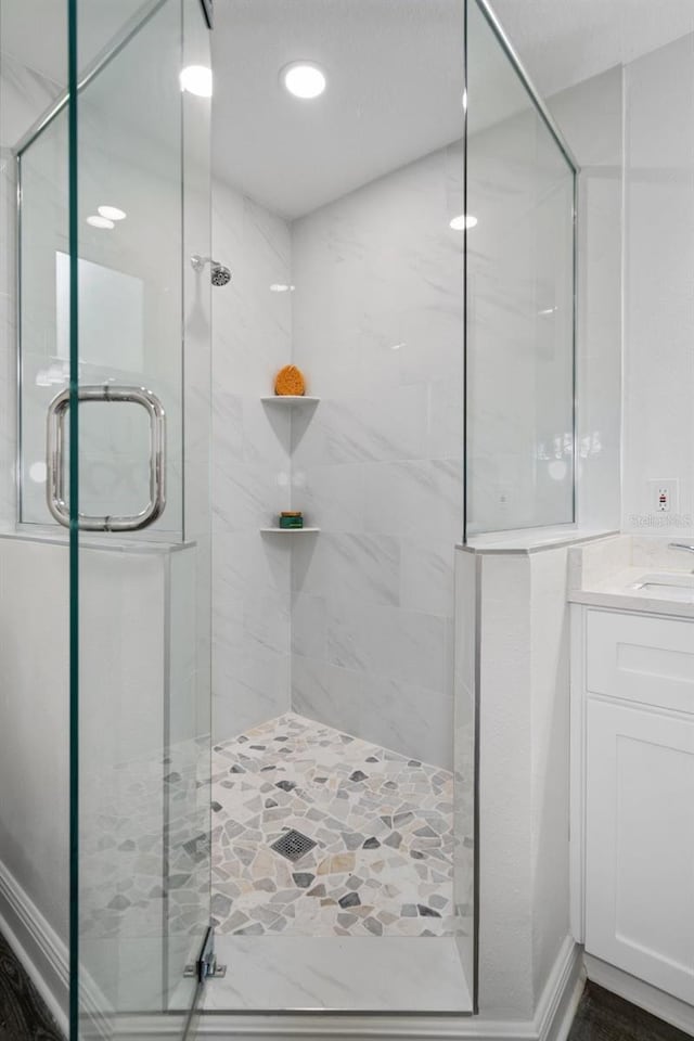 bathroom featuring an enclosed shower and vanity