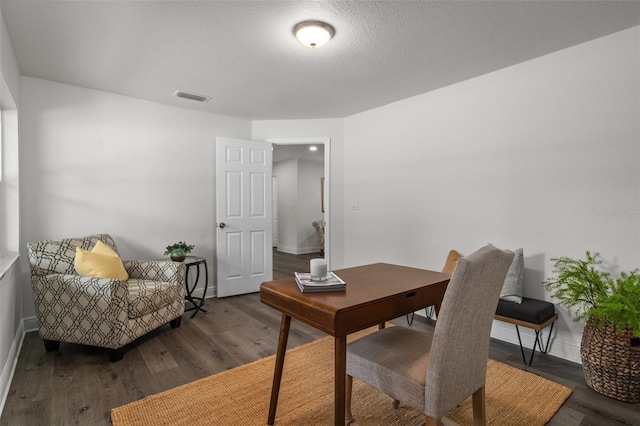 office space featuring a textured ceiling and dark hardwood / wood-style floors