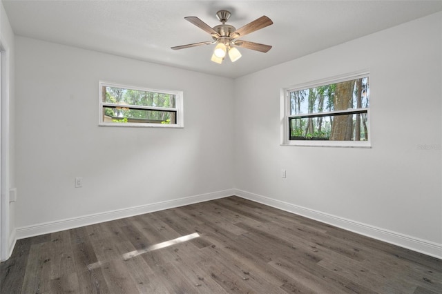 unfurnished room featuring ceiling fan and dark hardwood / wood-style floors