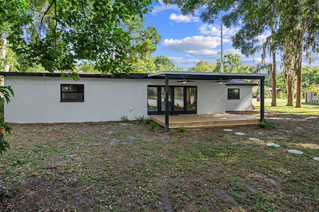 back of house featuring ceiling fan and a deck