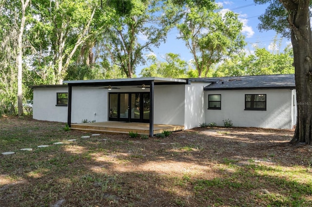 rear view of property featuring ceiling fan and a patio area