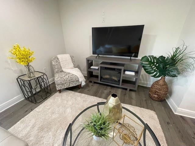 living room with dark wood-type flooring