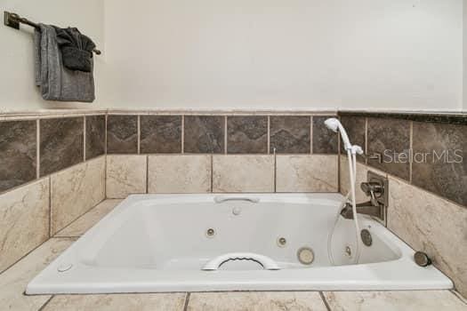 bathroom featuring tiled bath