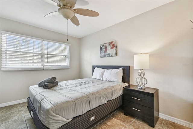 bedroom with ceiling fan and light tile patterned floors