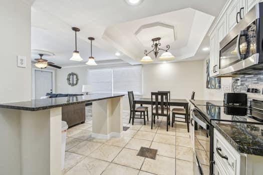 kitchen with hanging light fixtures, a center island, white cabinets, and appliances with stainless steel finishes