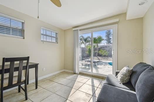 interior space with light tile patterned flooring and ceiling fan