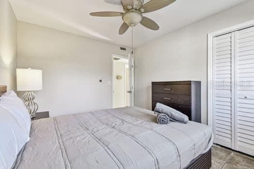 bedroom featuring ceiling fan and a closet