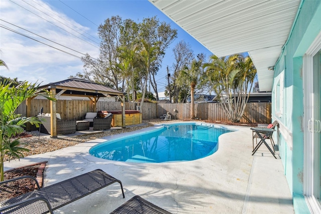 view of pool featuring a hot tub, a gazebo, outdoor lounge area, and a patio area