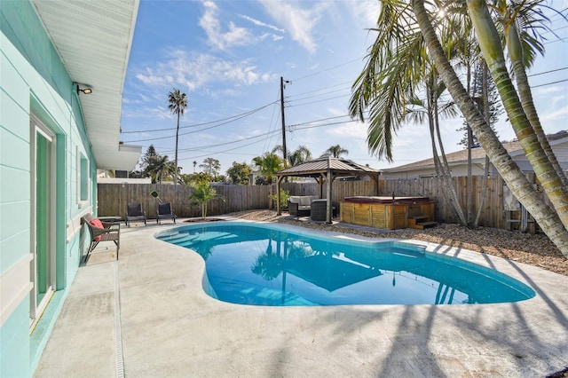 view of swimming pool featuring a gazebo, a hot tub, and a patio