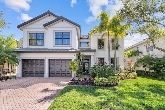 view of front of home featuring a garage and a front yard