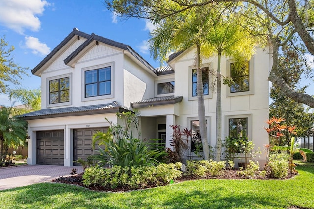 view of front of property with a garage, central air condition unit, and a front lawn