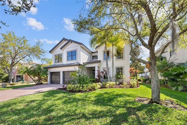 view of front of house featuring a garage and a front lawn