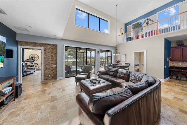 living room with light tile patterned floors and a high ceiling