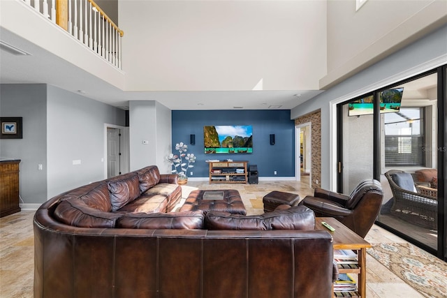 tiled living room with a towering ceiling