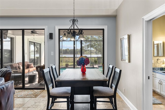 dining area with light tile patterned floors and a chandelier