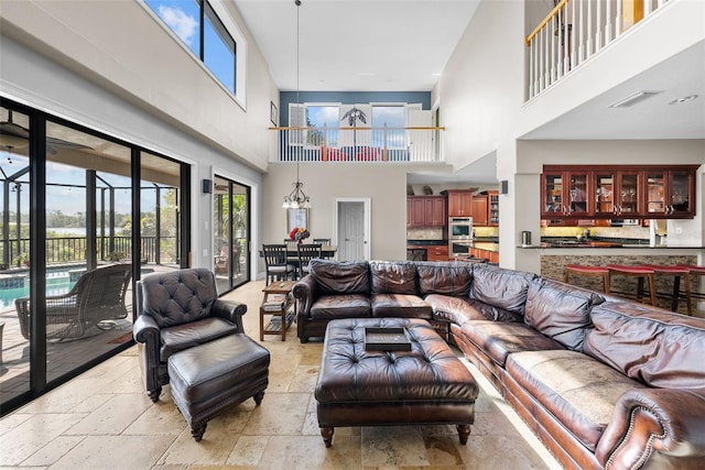 living room with light tile patterned flooring and a towering ceiling