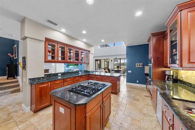 kitchen featuring kitchen peninsula, pendant lighting, a center island, appliances with stainless steel finishes, and light tile patterned floors