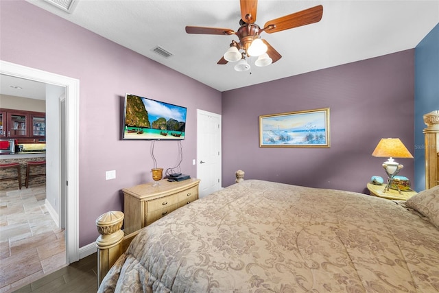 bedroom with tile patterned floors and ceiling fan