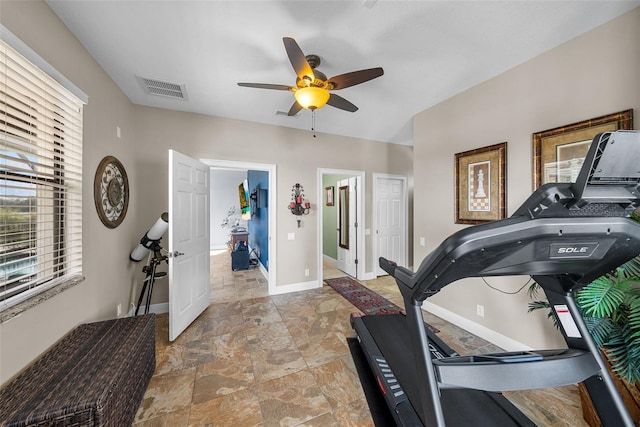 workout room featuring tile patterned flooring and ceiling fan