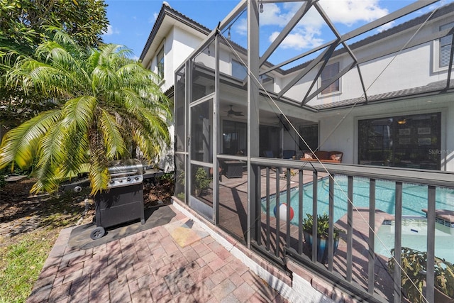 view of pool featuring a patio and glass enclosure