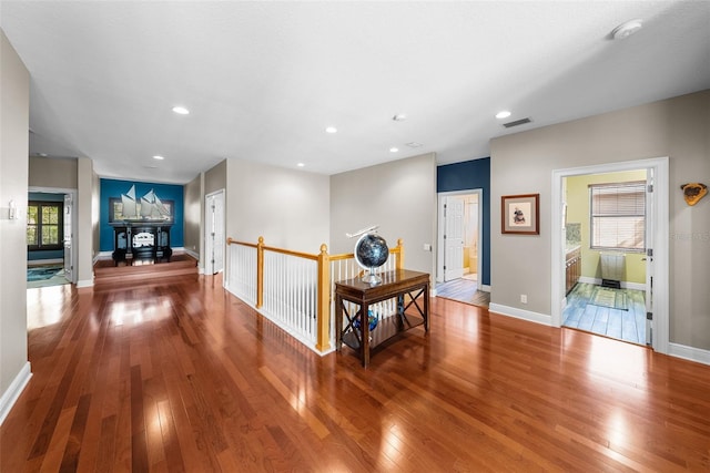 corridor featuring hardwood / wood-style floors