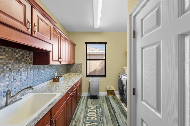 laundry room with sink, washer / dryer, and hardwood / wood-style floors