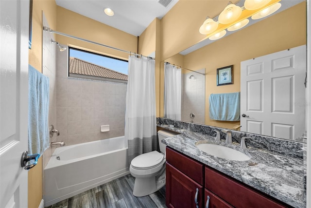 full bathroom featuring hardwood / wood-style flooring, shower / bathtub combination with curtain, toilet, and vanity