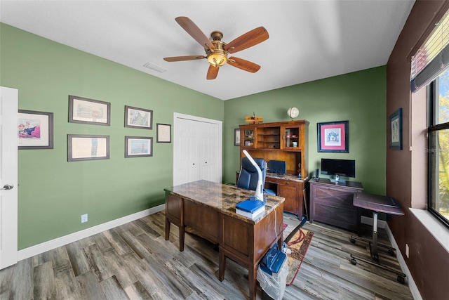 office area with ceiling fan and hardwood / wood-style floors