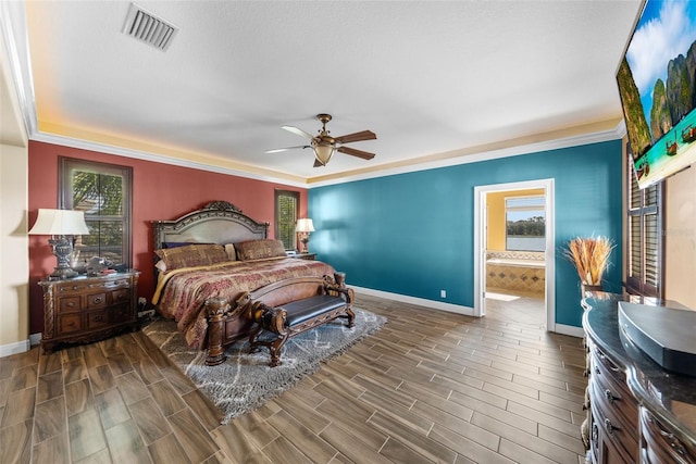 bedroom featuring hardwood / wood-style flooring, ensuite bath, ceiling fan, and crown molding