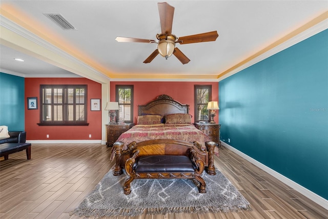 bedroom featuring crown molding, ceiling fan, and wood-type flooring