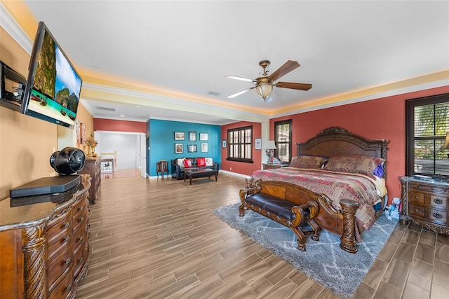 bedroom with hardwood / wood-style flooring, ornamental molding, and ceiling fan