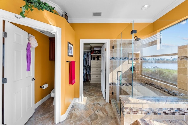 bathroom with toilet, a water view, a healthy amount of sunlight, and tile patterned flooring