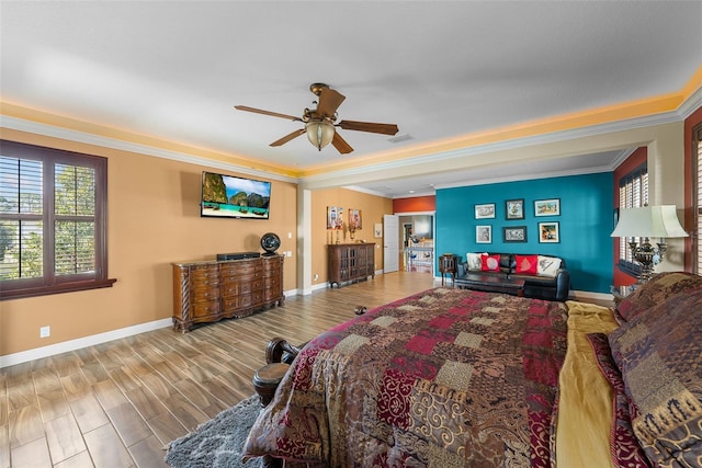 bedroom with ceiling fan, hardwood / wood-style flooring, and ornamental molding