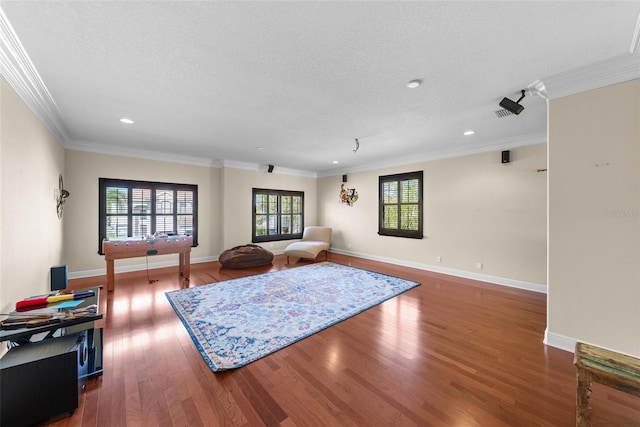 living room with ornamental molding, a textured ceiling, and dark hardwood / wood-style floors