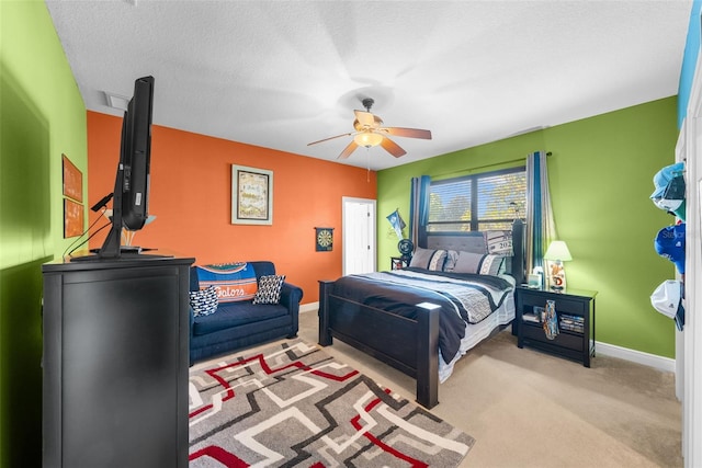 carpeted bedroom with a textured ceiling and ceiling fan