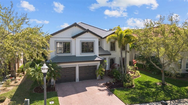 view of front of property featuring a garage and a front lawn