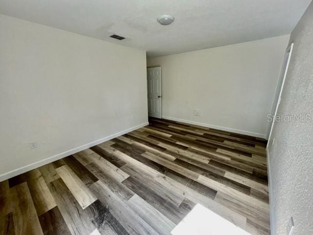 unfurnished room with hardwood / wood-style floors