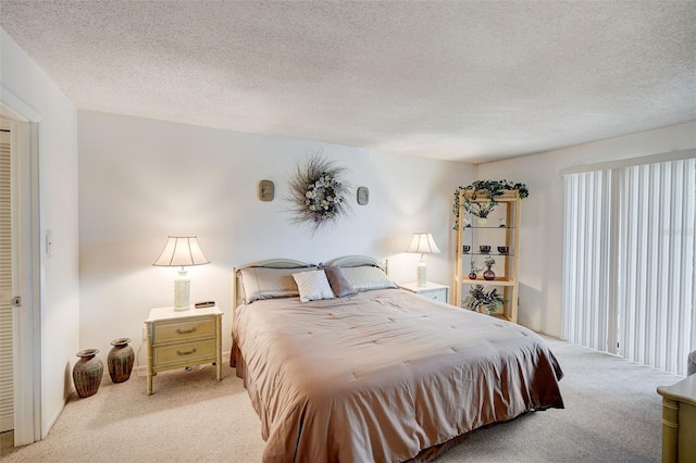 bedroom featuring a textured ceiling and carpet flooring