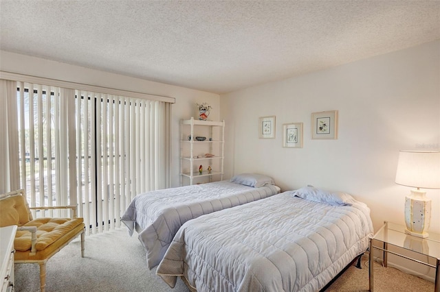 carpeted bedroom featuring a textured ceiling