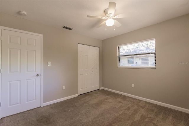 unfurnished bedroom with a closet, ceiling fan, and carpet floors