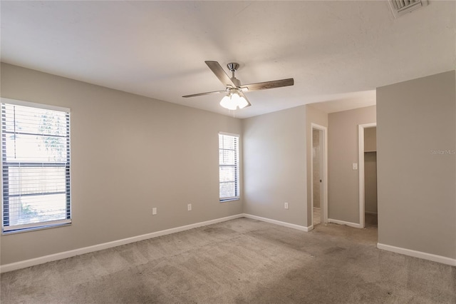 carpeted empty room with ceiling fan