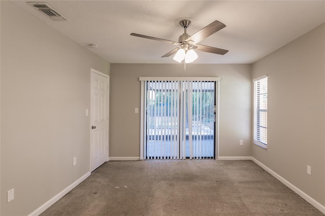 carpeted spare room featuring ceiling fan