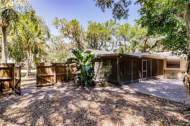 rear view of property with a sunroom